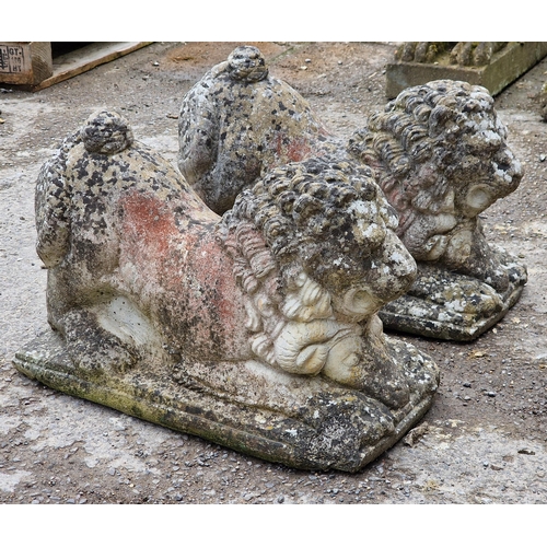 1098 - Pair of weathered reconstituted stone recumbent lions, H 34cm x W 28cm x D 54cm