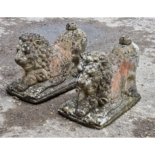 1098 - Pair of weathered reconstituted stone recumbent lions, H 34cm x W 28cm x D 54cm