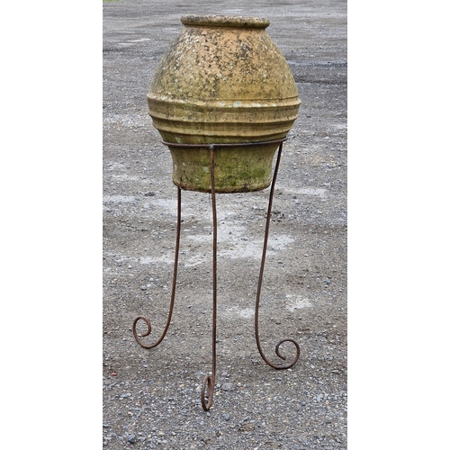 1101 - Weathered terracotta urn with banded detail raised on an associated scrolled metal stand, H 46cm (ur... 