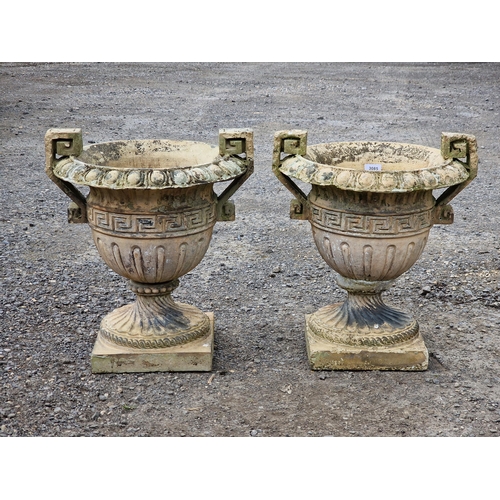 1126 - Pair of weathered reconstituted stone trophy shaped garden urns with flared egg and dart rims, spira... 