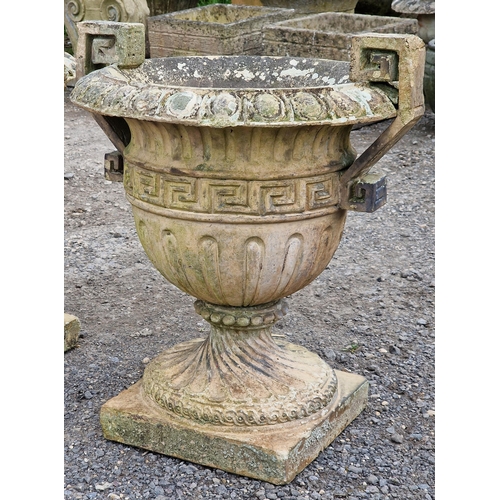 1126 - Pair of weathered reconstituted stone trophy shaped garden urns with flared egg and dart rims, spira... 