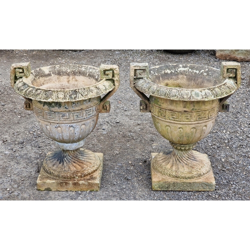 1126 - Pair of weathered reconstituted stone trophy shaped garden urns with flared egg and dart rims, spira... 