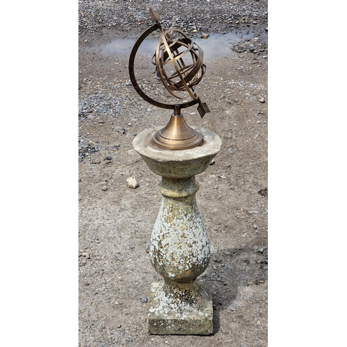 1129 - Brass armillary sphere raised on a reconstituted stone baluster column base, H 90cm