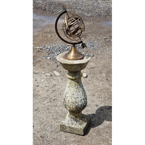 1129 - Brass armillary sphere raised on a reconstituted stone baluster column base, H 90cm