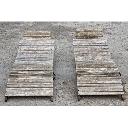 1196 - Pair of folding slatted teak loungers,190cm long (2)