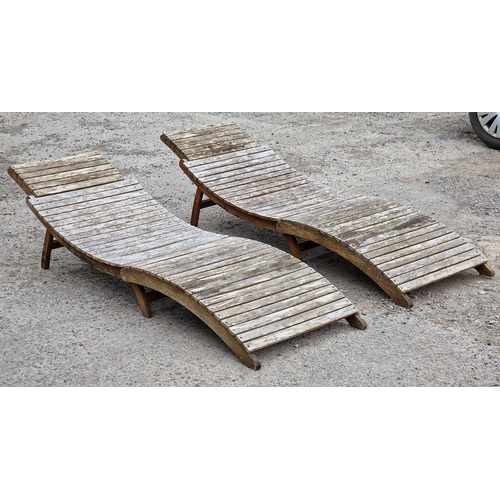 1196 - Pair of folding slatted teak loungers,190cm long (2)