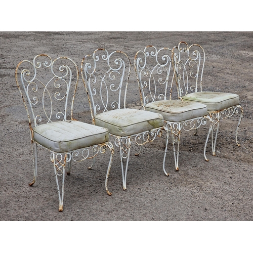 1202 - Set of four painted metal garden chairs with scrolling pierced detail and upholstered cushions, H 90... 