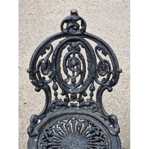 1214 - Three Victorian painted cast iron garden chairs with scrolling pierced detail, raised on swept suppo... 