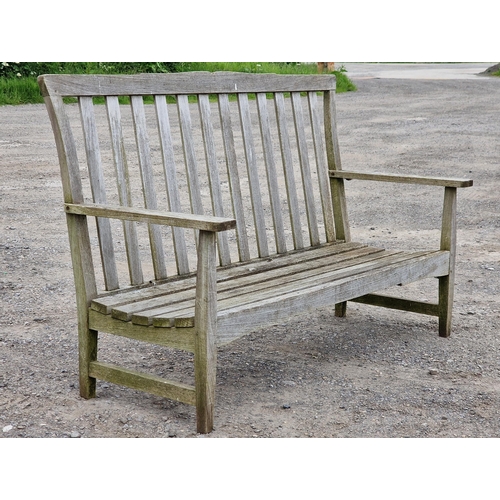 1232 - Three piece teak garden set to include a bench and two chairs with slatted seats and backs, raised o... 