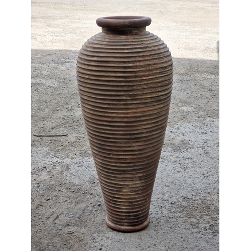 1242 - Terracotta amphora urn of tapered form with ribbed detail, H 99cm