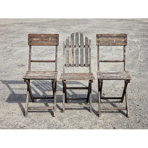 1221 - A pair of folding teak garden chairs with slatted seats and backs together with one other similar fo... 