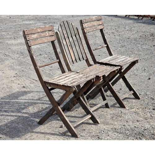 1221 - A pair of folding teak garden chairs with slatted seats and backs together with one other similar fo... 