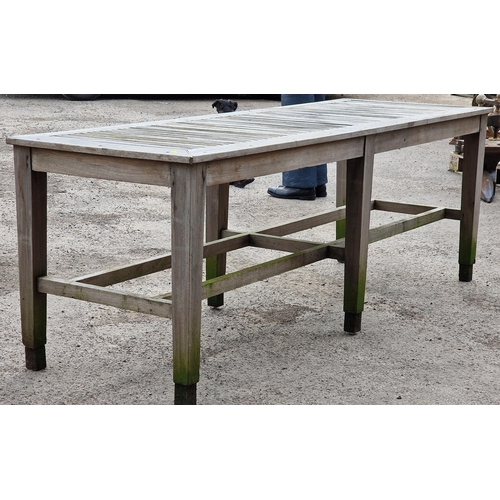 1020 - Good silvered teak potting bench/table the slatted top upon six legs with two stretchers, 76cm high ... 