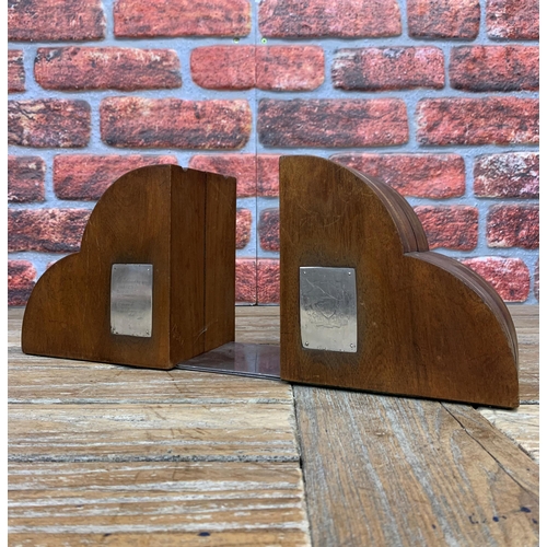 2171 - Pair of carved mahogany bookends inset with plaques, one displaying a coat of arms and another being... 