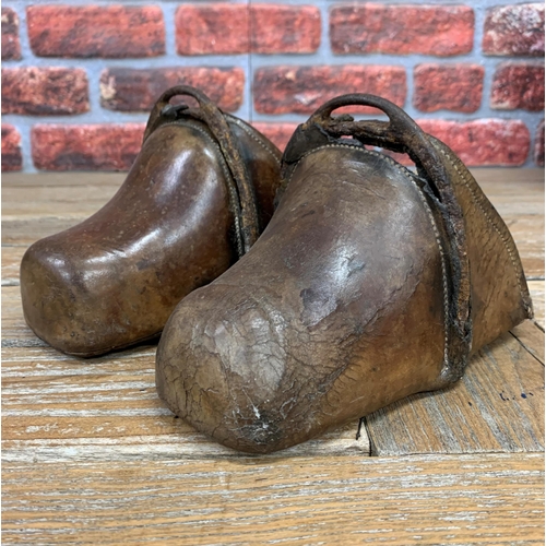 343 - Pair of antique 17th century brown leather hand forged Spanish horse stirrups, reinforced at the fro... 