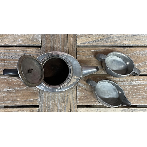 2234 - Archibold Knox for Liberty and Co of London Tudric pewter three piece tea service with hammered fini... 