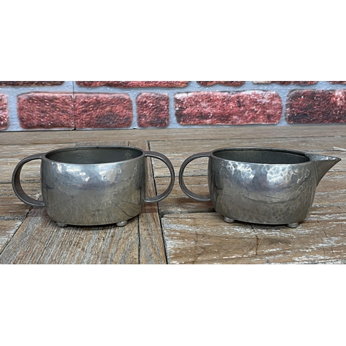 2234 - Archibold Knox for Liberty and Co of London Tudric pewter three piece tea service with hammered fini... 