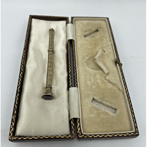 153 - Antique silver gilt propelling pencil, with amethyst knop, 7.5cm long, in leather box