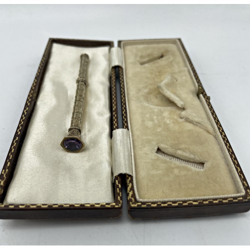 153 - Antique silver gilt propelling pencil, with amethyst knop, 7.5cm long, in leather box