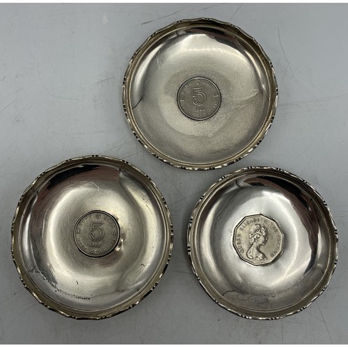 160 - Three Hong Kong silver pin dishes each fitted with a coin, 9.25cm diameter, 5oz approx (3)