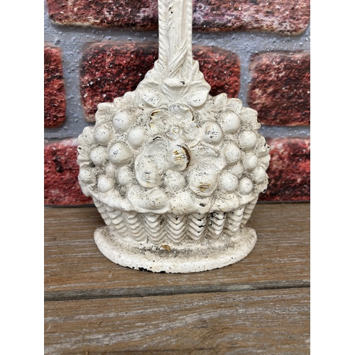 2265 - White cast iron doorstop in the form of fruit in a basket, H 45cm