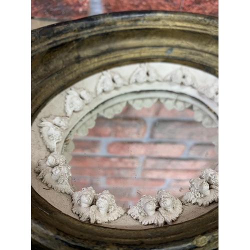 2438 - 19th century gilt vanity mirror with plaster relief of cherubs with original mercury glass, H 23cm x... 