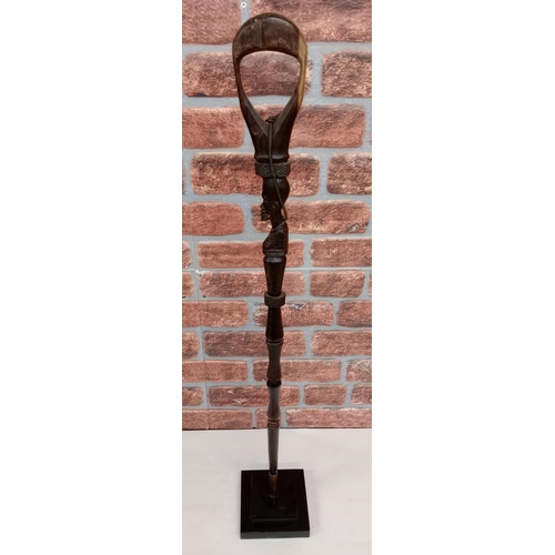 2133 - Vintage African Hand carved Ebony Staff carved in the figure of a man, displayed on heavy black Meta... 