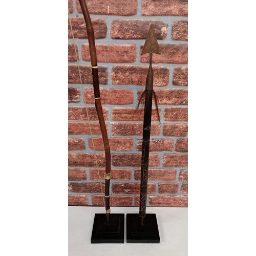 2136 - Vintage Leather wrapped Bow, H119 and top of an African Spear, H90cm, both displayed on heavy black ... 