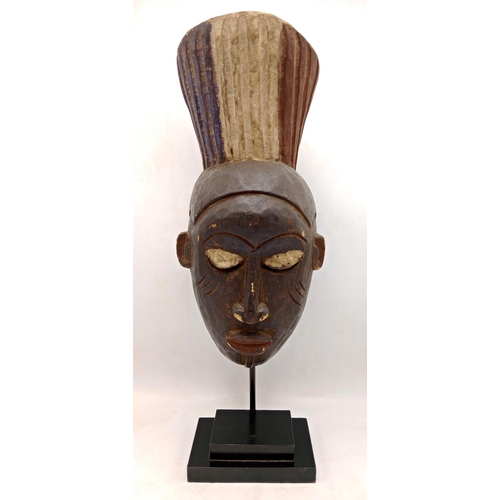 2142 - Vintage African Gabon Hand carved wooden Mask, displayed on heavy black Metal stand, H54cm