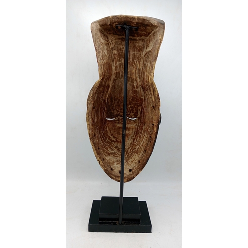 2142 - Vintage African Gabon Hand carved wooden Mask, displayed on heavy black Metal stand, H54cm