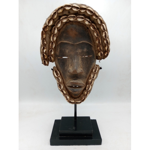 2143 - Vintage African Dan, Hand carved wooden Mask, displayed on heavy black Metal stand, H40cm