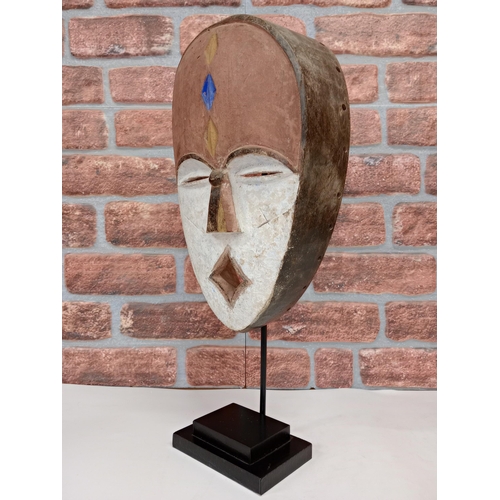 2144 - Vintage African Fang hand carved wooden Mask, displayed on heavy black metal stand, H54cm