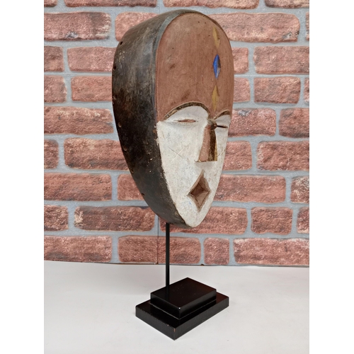 2144 - Vintage African Fang hand carved wooden Mask, displayed on heavy black metal stand, H54cm