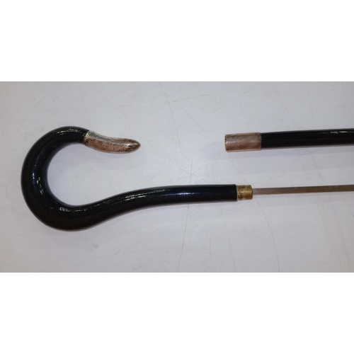 399 - A good quality ebony antique walking stick sword stick with a crook handle, mounted in silver and ma... 