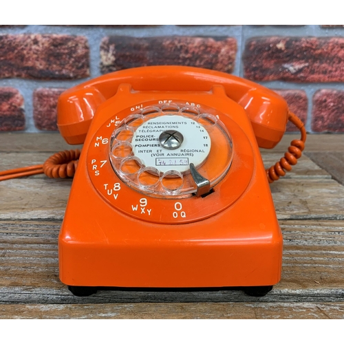 2300 - French rotary dial orange phone with listening in handset in a holder to the reverse