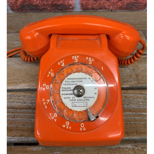 2300 - French rotary dial orange phone with listening in handset in a holder to the reverse