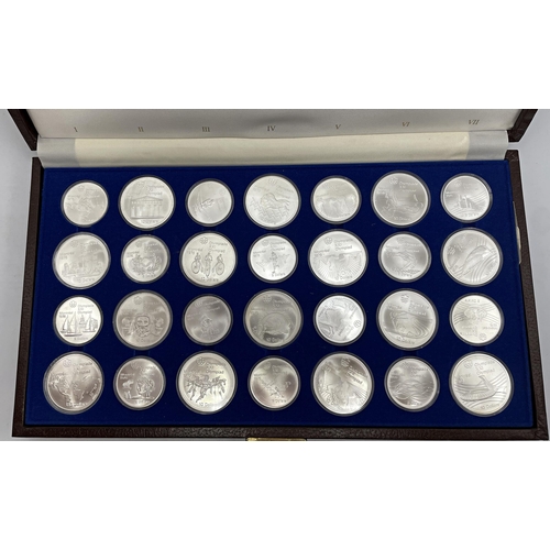 91 - Canadian Olympic Coins 1976 - Leather cased collection of 28 sterling silver coins, 45 and 38mm diam... 