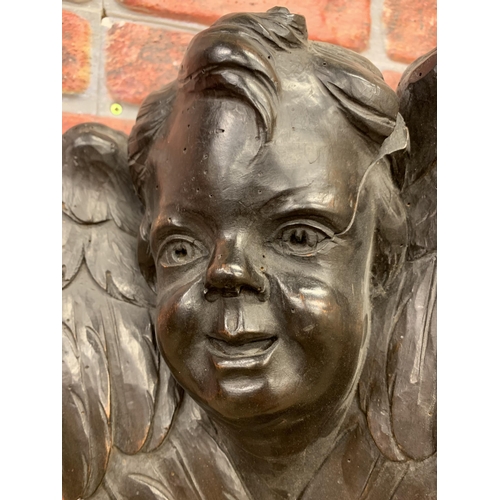 2175 - 19th century stained softwood cherub bracket, the well carved face flanked by crossed opposing wings... 