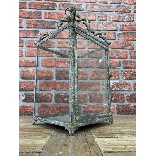 2389 - Large Victorian style hanging hall lantern with panelled glass finish and scrolled frame, H 65cm