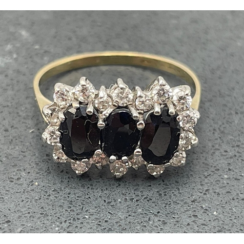 56 - 18ct sapphire and diamond three stone cluster ring, three .50ct sapphires framed by fourteen diamond... 