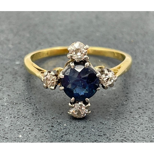 65 - 18ct sapphire and diamond cross ring, central .80ct stone flanked by four .15ct diamonds, size N, 3g