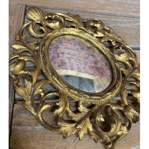 2415 - Antique repousse gilt cushioned mirror having original bevelled glass with floral and scalloped surr... 