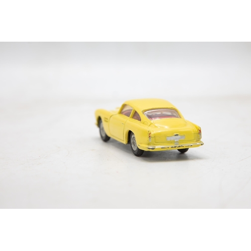 3283 - Corgi Toys 218 Aston Martin D.B.4, yellow, cast spoked wheels, very near mint, and boxed