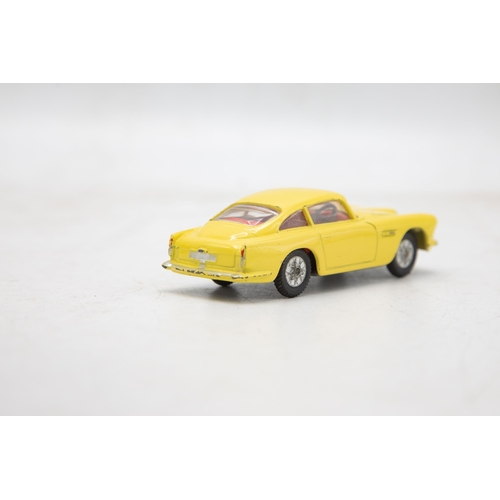 3283 - Corgi Toys 218 Aston Martin D.B.4, yellow, cast spoked wheels, very near mint, and boxed