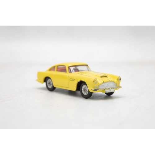 3283 - Corgi Toys 218 Aston Martin D.B.4, yellow, cast spoked wheels, very near mint, and boxed