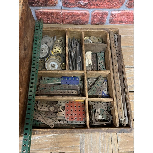 3411 - Large quantity of early Meccano held in wooden crate with further assortment of manuals and instruct... 