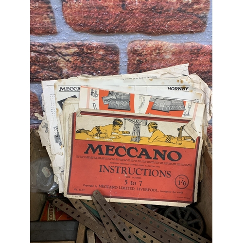 3411 - Large quantity of early Meccano held in wooden crate with further assortment of manuals and instruct... 