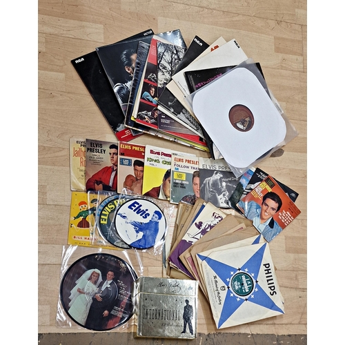 3613 - Assortment of Elvis Presley related items to include vinyl singles, albums and 78's, together with C... 