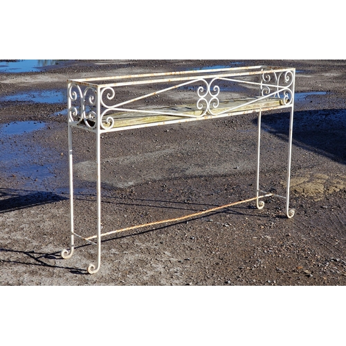 1309 - A painted wrought iron plant stand with scroll work detail, H 71cm x W 106cm x D 21cm