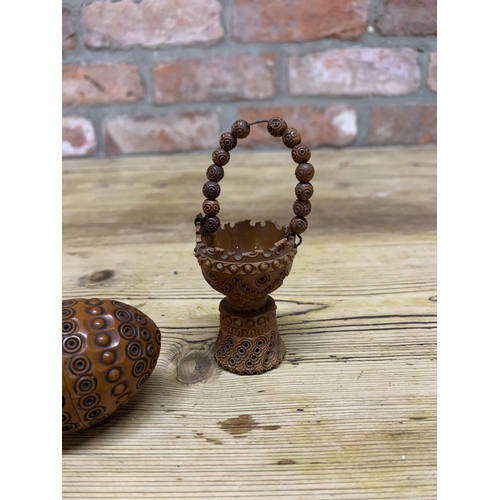 77 - Two Victorian hand carved treen coquilla nut baskets with similar cocquilla egg shaped sewing box (3... 